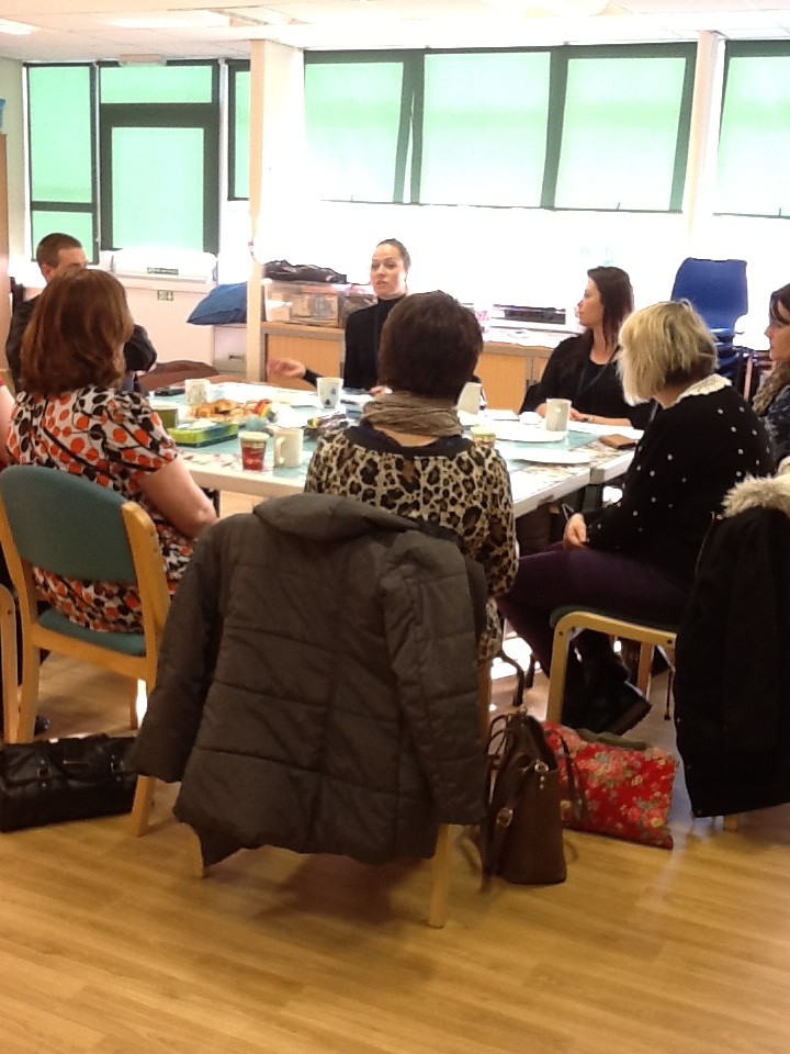 Parents and carers seated round a table at a RAGS support meeting