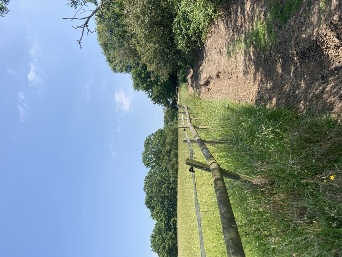 Wooden fence along a grassy path on a countryside walk