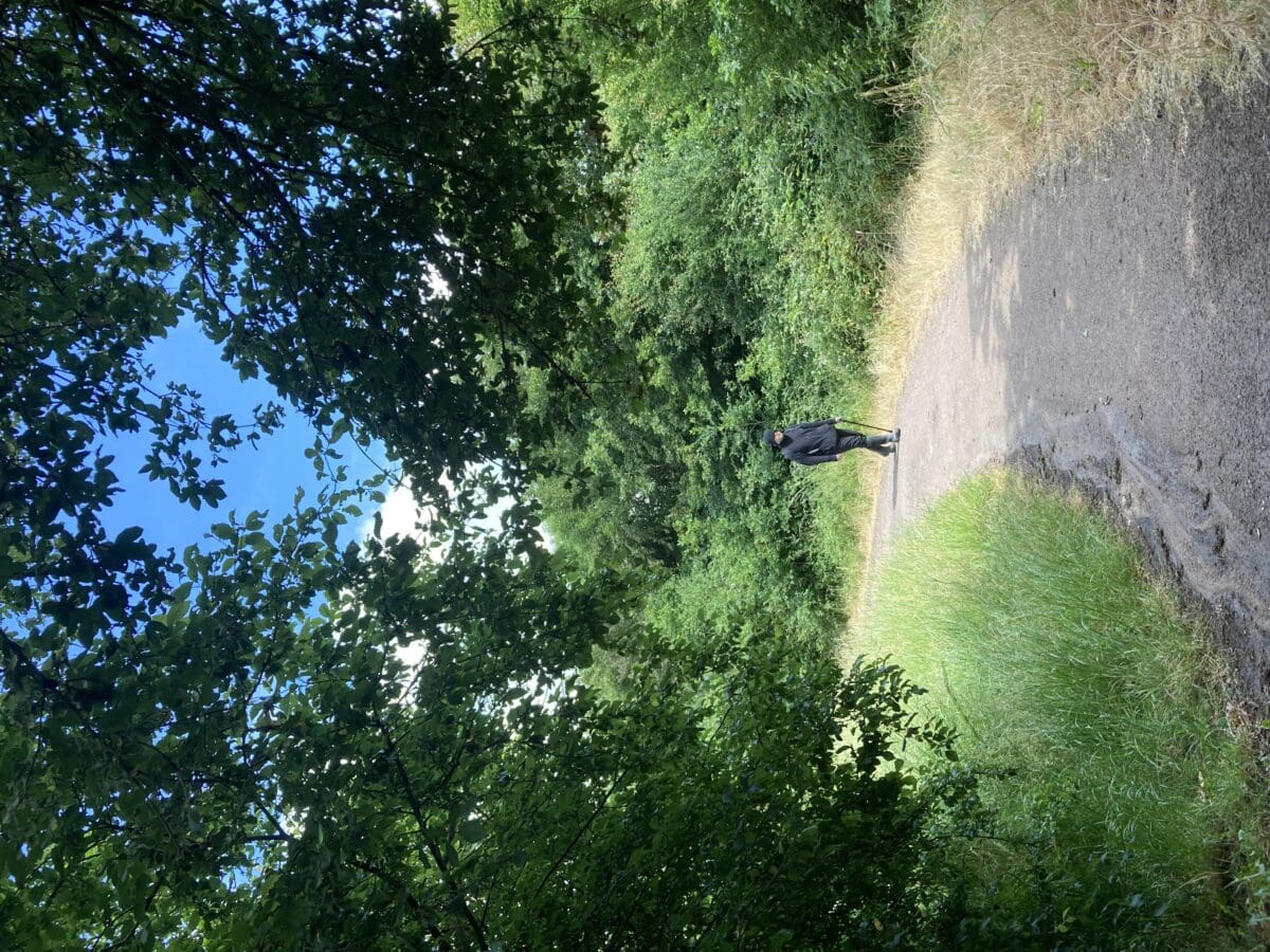 Person walking along a wooded track on a countryside walk