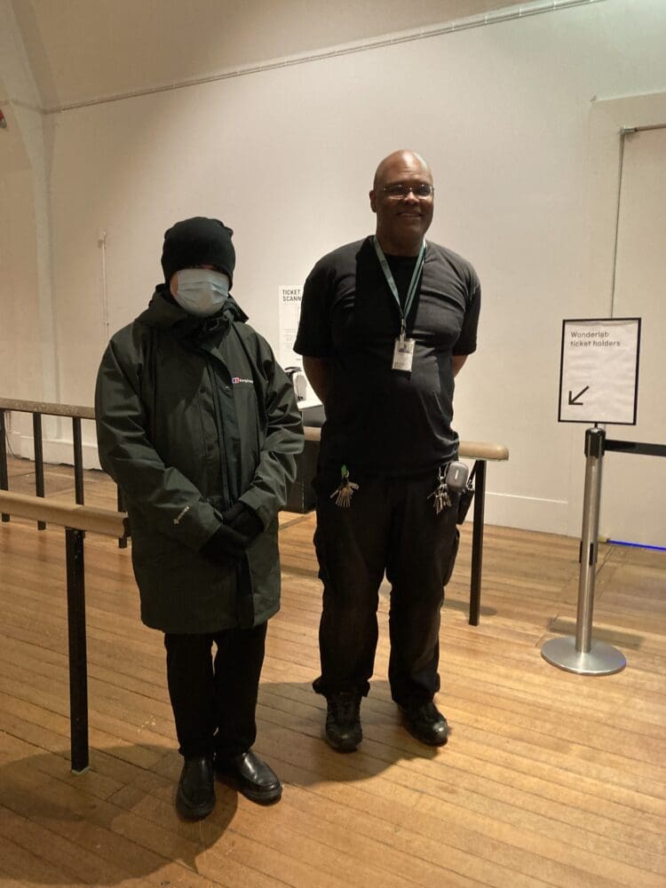 Two RAGS volunteers standing together at an indoor event