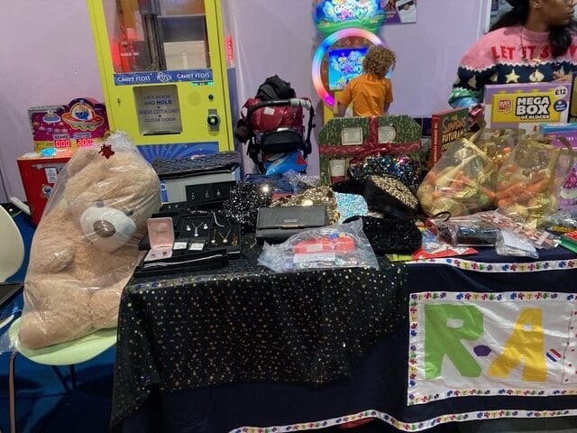 RAGS stall with teddy bear, jewellery and sweet hamper raffle prizes