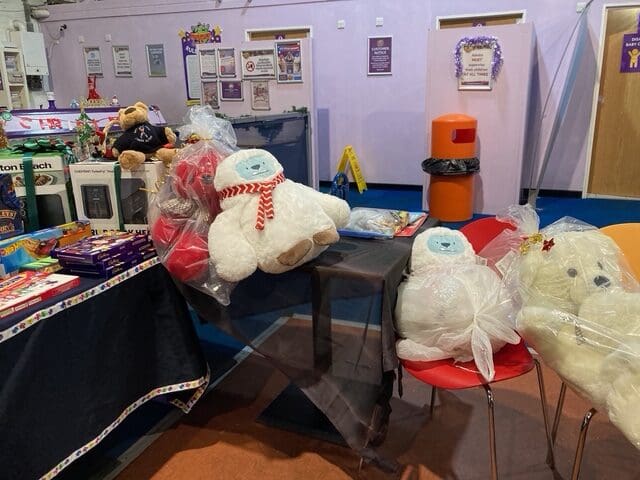 Cellophane-wrapped polar bear teddies displayed as raffle prizes