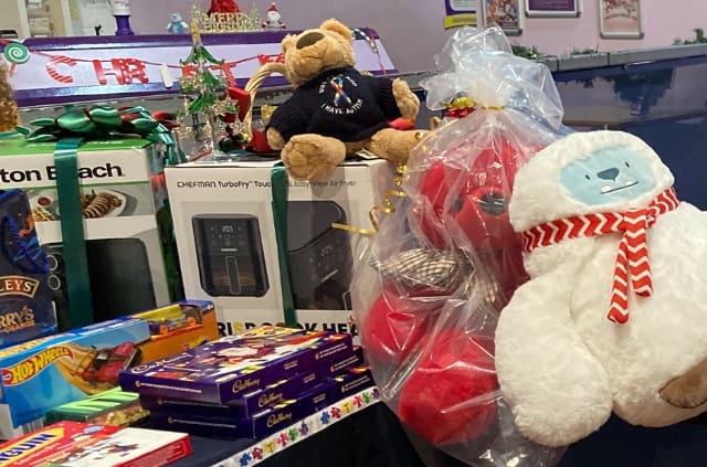 Christmas raffle prizes and gifts on display at a RAGS Christmas party