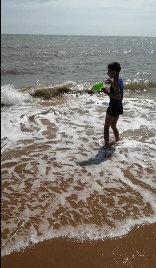 A child playing in the sea waves at Walton-on-the-Naze