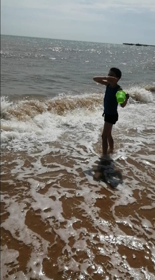 Child playing in the sea waves on a RAGS beach trip