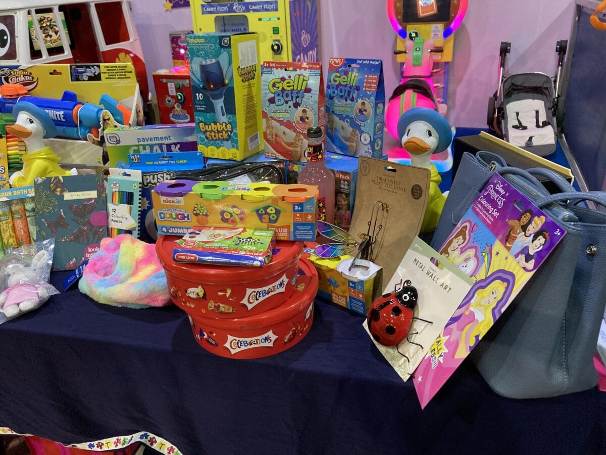 Raffle prize table with toys, colouring sets and handbags at a RAGS fundraiser