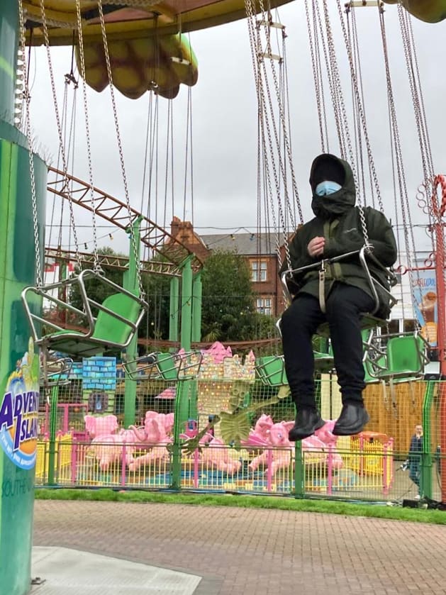 Person riding a swing carousel at Adventure Island theme park