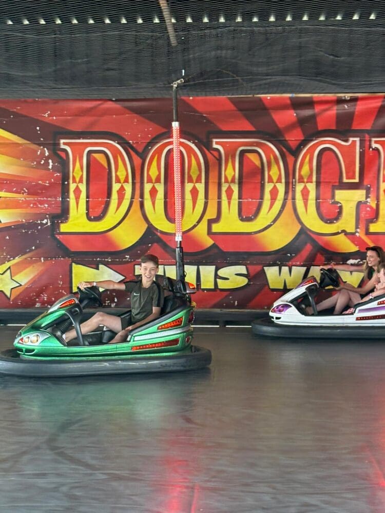 Young person riding a dodgem car at a fairground