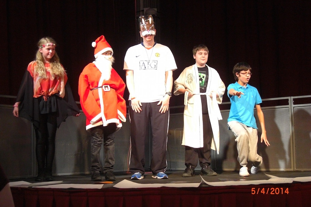Group of children in fancy dress costumes on stage at a RAGS event, 2014
