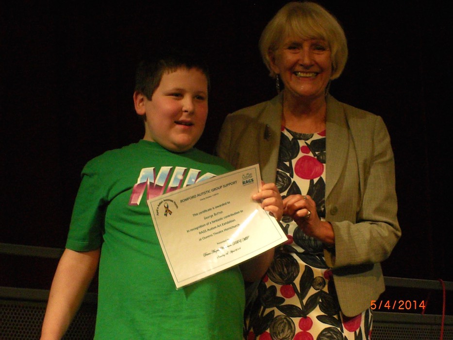 Boy receiving a RAGS Autism Art Exhibition certificate, 2014