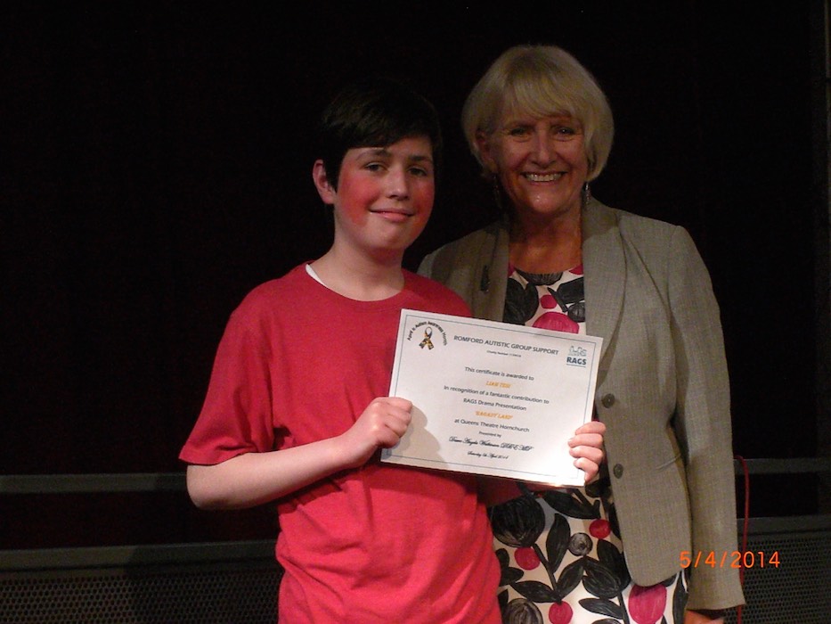 Boy holding his certificate for the RAGS drama presentation, 2014