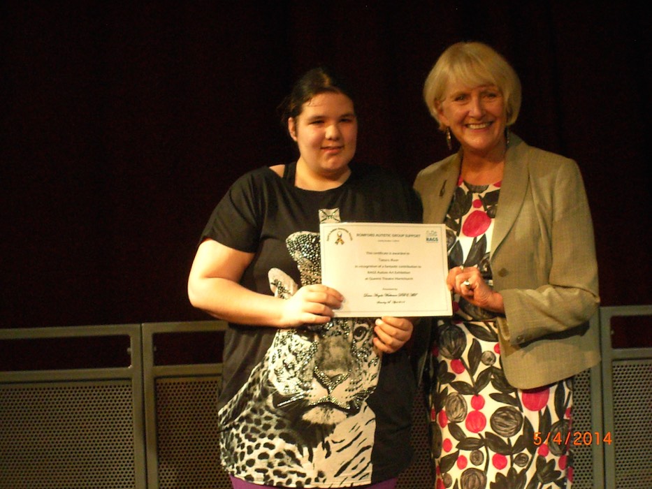 Girl holding her RAGS Autism Art Exhibition certificate, 2014