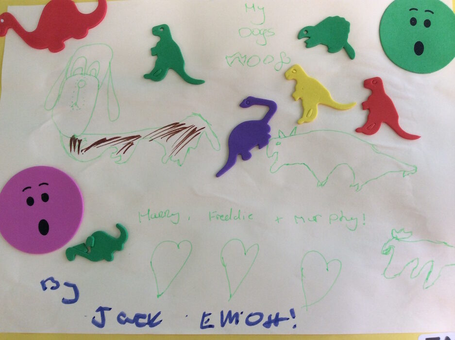 Child's artwork of dinosaurs, a dog and hearts titled My Dogs Woof