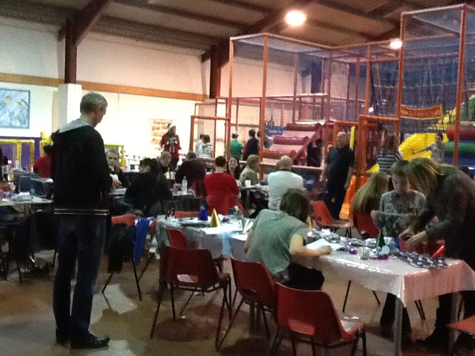 Children doing crafts at tables during RAGS Christmas party