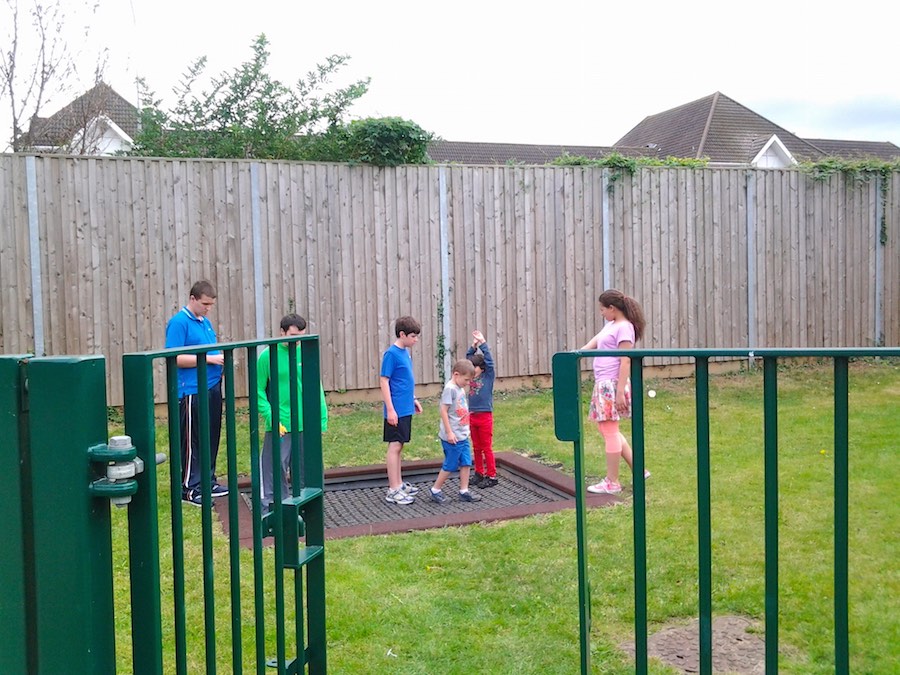 Children gathered around a garden trampoline, RAGS summer club 2014