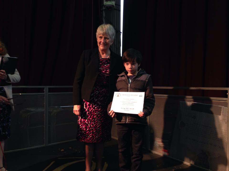 Boy receiving his certificate from the Mayor at a RAGS awards event