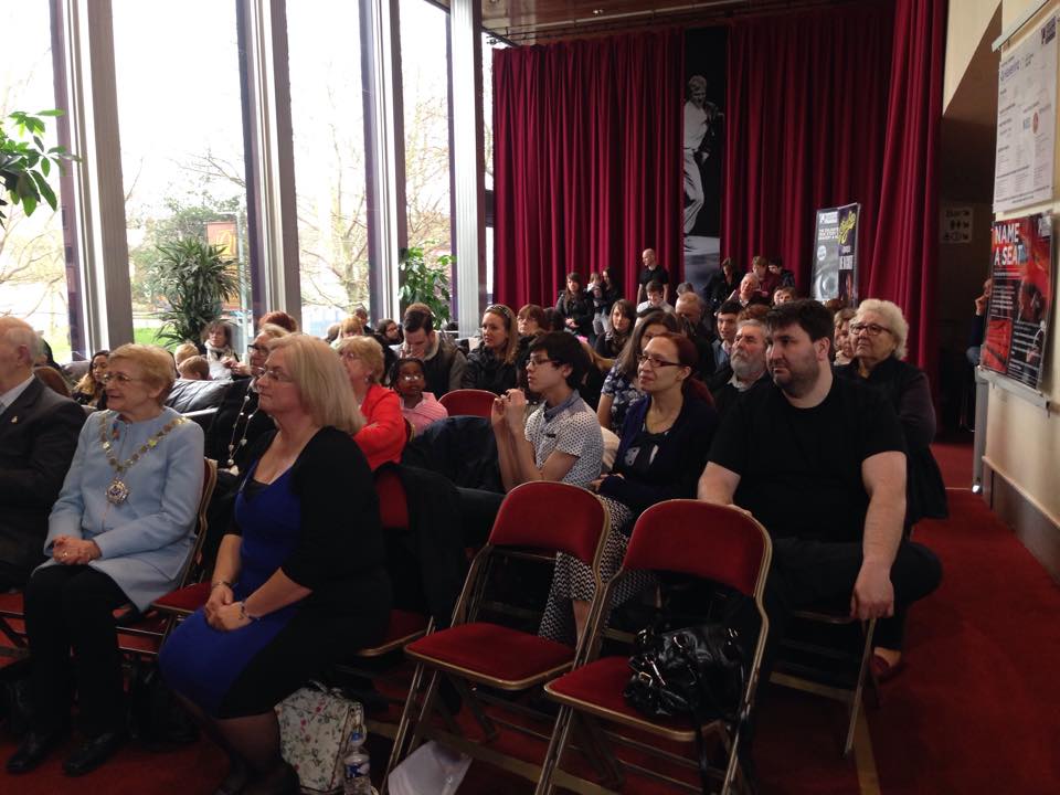 Audience seated in a theatre awaiting the RAGS Autism Art Exhibition awards