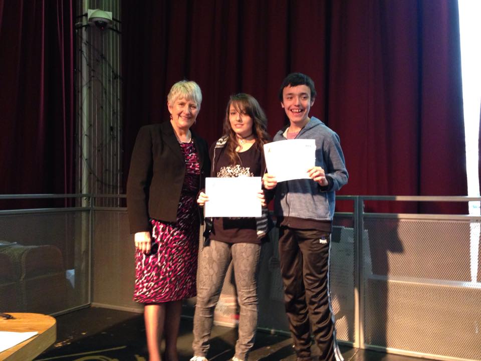 Two teenagers holding certificates with the Mayor at a RAGS awards event