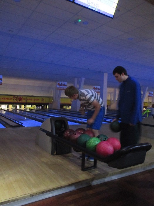 Members choosing bowling balls at a RAGS bowling trip, 2014