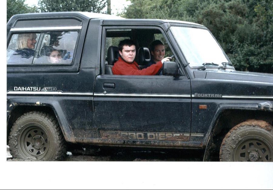 Family group riding in a 4x4 vehicle during a RAGS outing, 2014