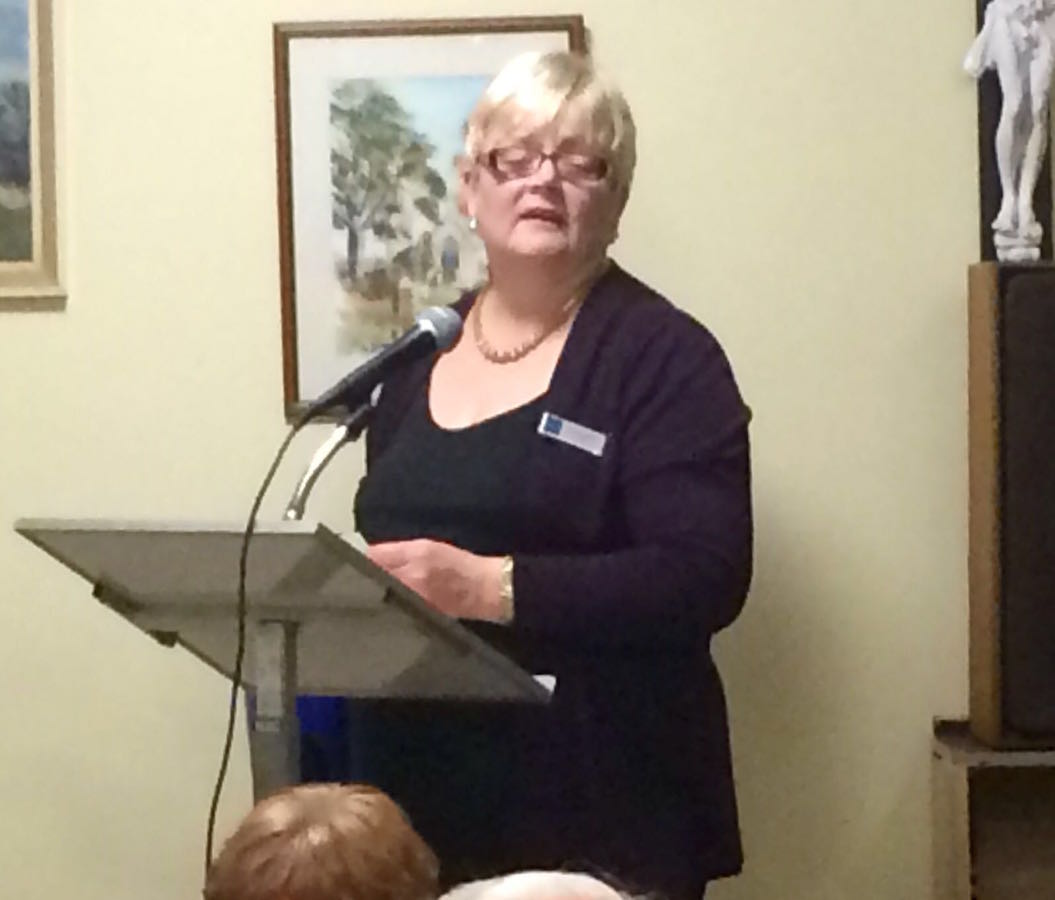 Woman speaking at a podium during a RAGS quiz night, 2016