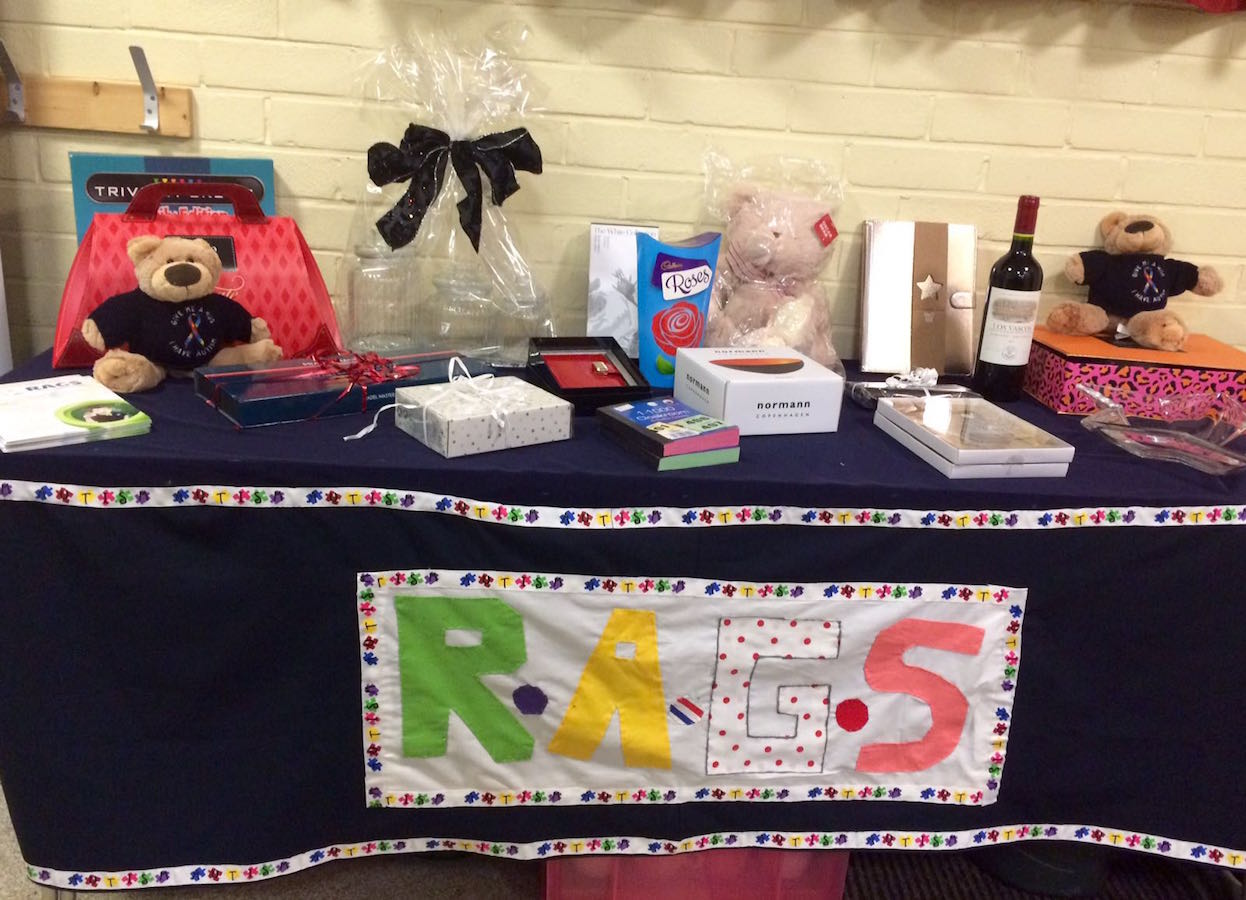 Raffle prize table with teddy bears and gifts at RAGS quiz night